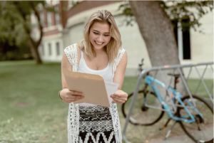 Student Success with Southampton Assignment Help A jubilant student showcasing an A+ paper, a testament to our tailored assignment help in Southampton.