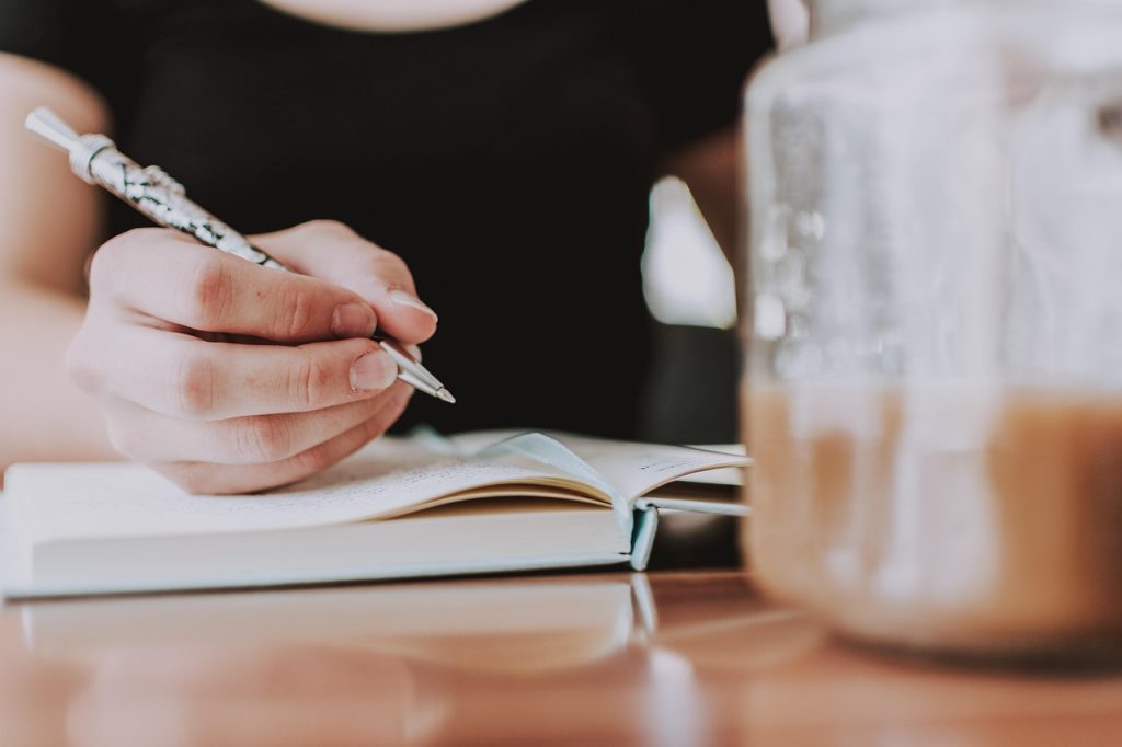 Law essay checklist and template planning with pen on notebook (UK)