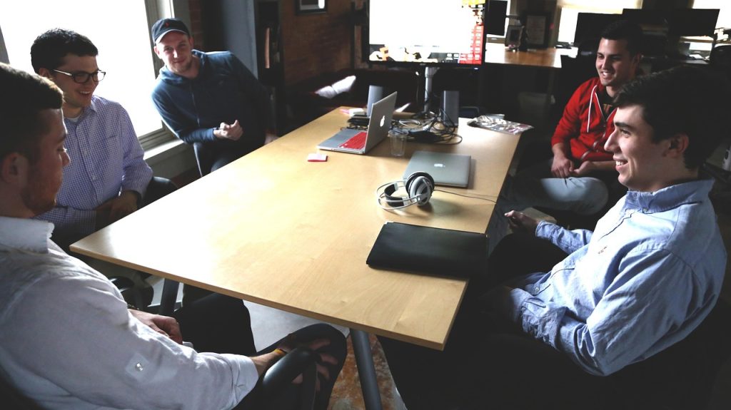 Business Assignment Help UK – strategy meeting with laptops and notes